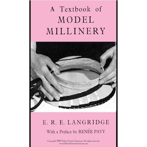May include: A vintage book cover with the title "A Textbook of Model Millinery" in black text on a pink background. The image shows hands working on a hat form. The author is E. R. E. Langridge.
