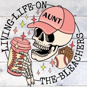 May include: A pink and white illustration of a skull wearing a pink baseball cap with the word "AUNT" on it. The skull is holding a pink and white coffee cup and a baseball. The illustration is surrounded by a circle with the text "LIVING LIFE ON THE BLEACHERS".
