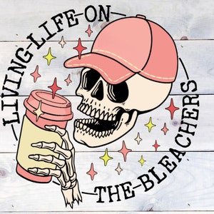 May include: A cartoon skull wearing a pink baseball cap and holding a coffee cup. The skull is surrounded by a circle with the text "Living Life On The Bleachers".
