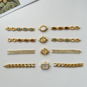 May include: An assortment of vintage gold-toned watches and watch bands. The watches have oval and rectangular faces with various dial designs. The bands feature decorative links with gemstones and pearl accents. Some bands are solid link styles.