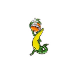 May include: A colorful enamel pin featuring a cartoon alligator holding an orange with the word "BRANCA" on it. The alligator is green and yellow, and the orange has a white flower and green leaves.