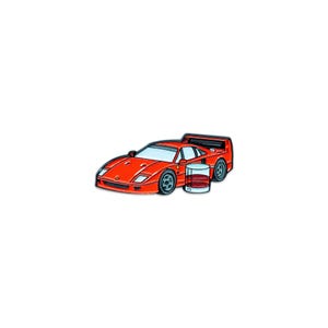 May include: A red sports car and a glass of whiskey are depicted in this illustration. The car has a sleek design with black wheels and a spoiler. The glass is filled with a brown liquid, suggesting whiskey or a similar beverage.