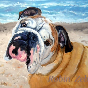 May include: A painting of a bulldog with a white and brown coat, looking to the side with its mouth slightly open. The dog is on a sandy beach with blue water in the background. The painting is signed "Robin Zebley".