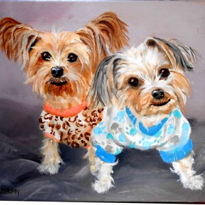 May include: Painting of two small, brown and white dogs wearing sweaters. The dog on the left is wearing a leopard print sweater with an orange collar. The dog on the right is wearing a blue and white sweater with paw prints. The dogs are sitting on a gray background.