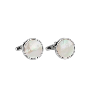 May include: A pair of silver cufflinks with a round, iridescent mother-of-pearl center. The cufflinks have a polished, reflective finish and a classic design, suitable for formal wear.