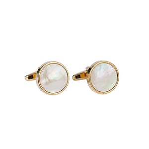 May include: A pair of gold-toned cufflinks with a round, iridescent mother-of-pearl center. The cufflinks have a classic design, suitable for formal wear or adding a touch of elegance to any outfit.