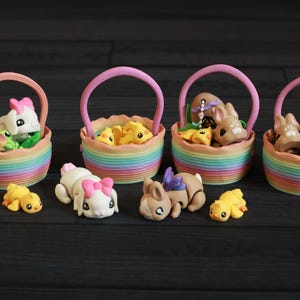 May include: Five colorful rainbow baskets filled with small animal figurines. The baskets are made of plastic and have a woven look. The figurines include a bunny, a deer, a chick, and a dog.