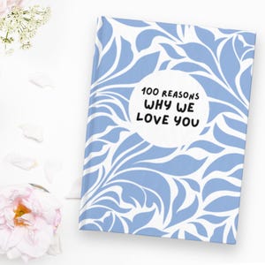 May include: A blue and white patterned journal with the text "100 Reasons Why We Love You" in a white circle.
