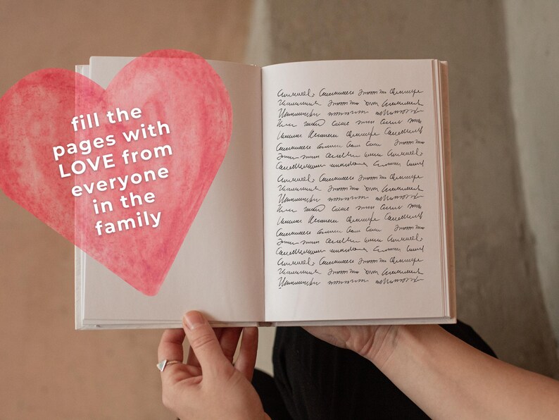 May include: A white journal with a pink watercolor heart on the front cover. The heart has the text "fill the pages with LOVE from everyone in the family" written on it. The journal is open to a page with handwritten text.