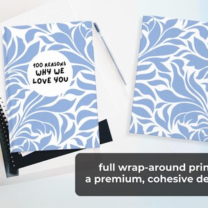 May include: A blue and white patterned journal with the text "100 Reasons Why We Love You" in a white circle. The journal has a full wrap-around print for a premium, cohesive design.