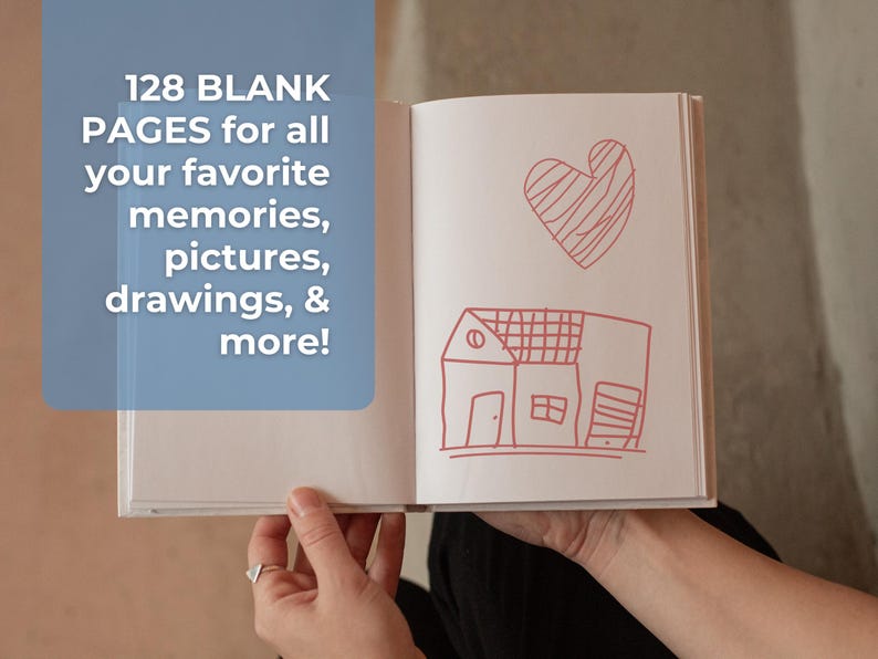 May include: A white blank notebook with 128 pages, open to reveal a red hand-drawn heart and house. The text "128 BLANK PAGES for all your favorite memories, pictures, drawings, & more!" is visible on the left page.