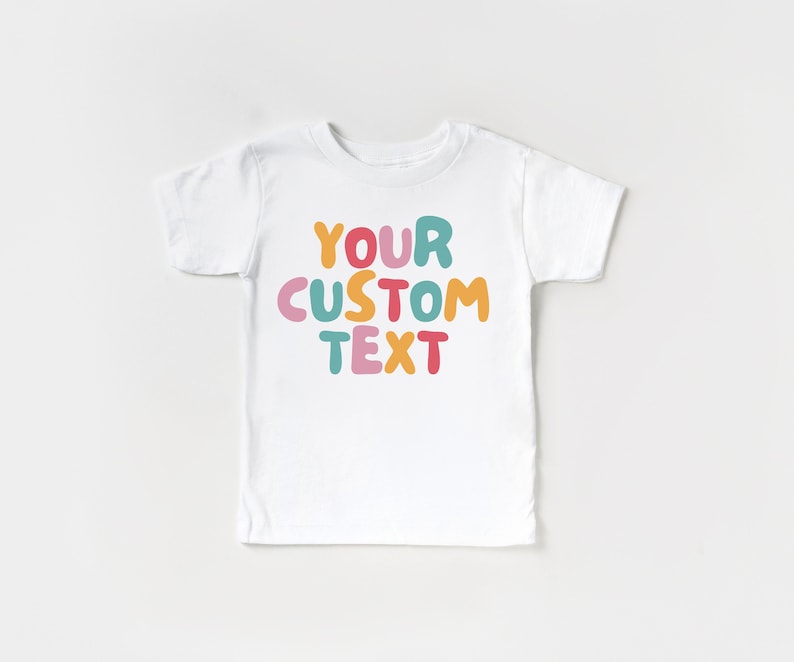 May include: White t-shirt with the text "YOUR CUSTOM TEXT" in colorful, bubble-like letters.