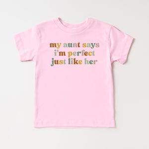 May include: Pink toddler t-shirt with the text "my aunt says i'm perfect just like her" in colorful letters.