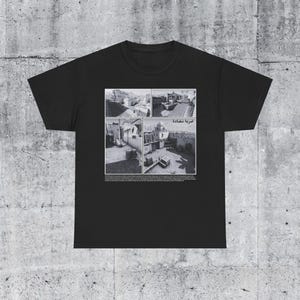 May include: Black t-shirt featuring a collage of four black and white photographs of a building with the text "المدينة القديمة" in Arabic.