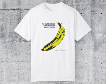 May include: White t-shirt with a yellow banana graphic and the text "The Counterstrike Global Offensive Limited Edition" and "Rush Banana" printed on the front.
