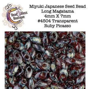 May include: Miyuki Japanese seed beads in the Long Magatama shape, measuring 4mm by 7mm. These beads are color #4504, Transparent Ruby Picasso, featuring a deep red base with mottled blue and cream surface accents and a distinct side-drilled hole.