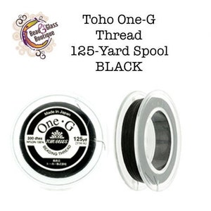 May include: Two spools of Toho One-G Beading Thread, one black and one white. Each spool contains 125 yards of thread.