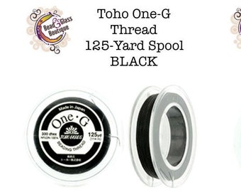 May include: Two spools of Toho One-G Beading Thread, one black and one white. Each spool contains 125 yards of thread.
