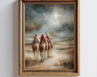 May include: A framed painting depicts three figures on camels, illuminated by a bright star in a night sky. The figures wear red and white robes, riding through a desert landscape. The artwork is in a gold frame, with the text "DESIGNSBYNADIO" at the bottom.