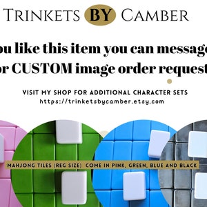 May include: Four sets of Mahjong tiles in pink, green, blue, and black. Each set has a white tile in the center. The text reads "MAHJONG TILES (REG SIZE) COME IN PINK, GREEN, BLUE AND BLACK".