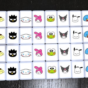 May include: A set of 25 white square tiles with colorful cartoon images. The tiles feature a variety of characters, including a black and white cat, a pink bunny, a green frog, a blue bird, and a white dog. The tiles are arranged in a 5x5 grid.