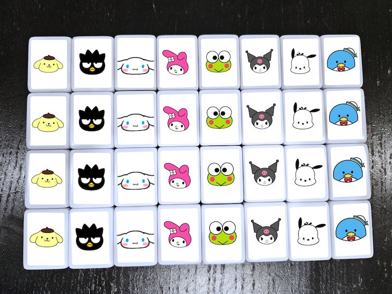May include: A set of 25 white square tiles with colorful cartoon images. The tiles feature a variety of characters, including a black and white cat, a pink bunny, a green frog, a blue bird, and a white dog. The tiles are arranged in a 5x5 grid.