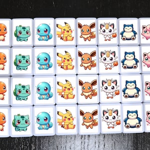 May include: A set of 36 white square tiles with colorful cartoon images of Pokemon characters. The tiles are arranged in a 6x6 grid. Each tile features a different Pokemon character, including Pikachu, Charmander, Squirtle, Bulbasaur, and more.