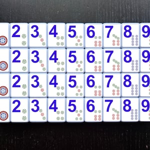 May include: A set of 36 white tiles with blue numbers 1 through 9. Each tile has a different pattern of colored dots in red, green, and blue.