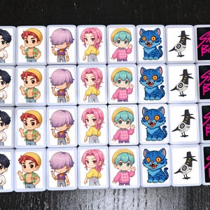 May include: A collection of rectangular tiles featuring cartoon illustrations. The tiles display various characters with different hair colors, a blue cat, a bird, and the text "Saja Boys" in pink.