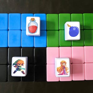 May include: Four white tiles with colorful cartoon images. The top left tile has a red potion bottle, the top right tile has a blue bomb, the bottom left tile has a green-clad character with orange hair holding a sword, and the bottom right tile has a blonde character in a pink dress.
