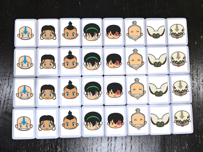 May include: A collection of white rectangular tiles, each featuring a cartoon character's face. The characters include a bald boy with an arrow tattoo, a girl with dark hair, a boy with a topknot, a girl with a green headband, a boy with a scar, an elderly man, a flying bison, and a lemur.