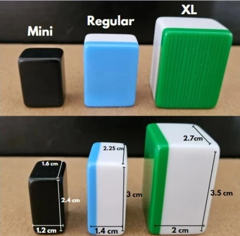 May include: Three sizes of Mahjong tiles are displayed: Mini, Regular, and XL. The Mini tile is black, the Regular tile is blue and white, and the XL tile is green and white. Measurements are provided in centimeters: Mini (1.2 x 1.6 x 2.4 cm), Regular (1.4 x 2.25 x 3 cm), and XL (2 x 2.7 x 3.5 cm).