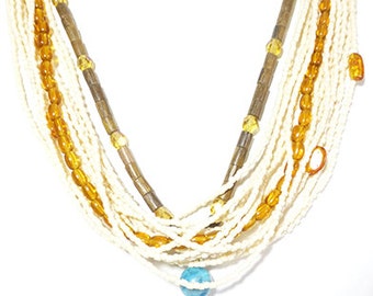 Multistrand necklace centered around a gorgeous artisan glass bead