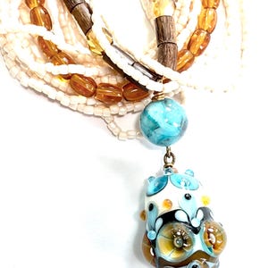 Multistrand necklace centered around a gorgeous Cornelia Lentze glass bead
