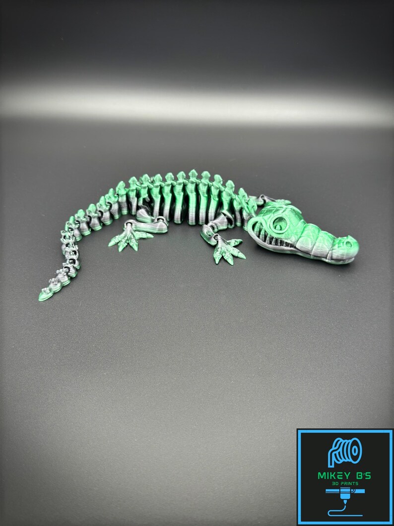 3D printed alligator or crocodile with a a black and green color.