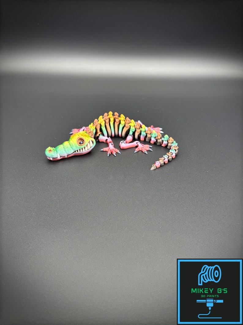 Multi Colored 3D printed crocodile or alligator Skeleton. Fast color changing rainbow for the head with white teeth, and Alternating ribs.