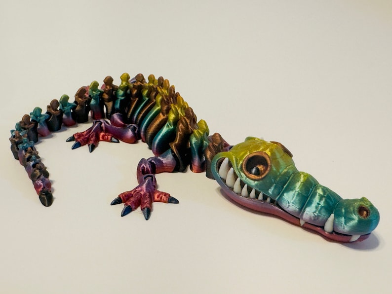 Multi Colored 3D printed crocodile or alligator Skeleton. Fast color changing rainbow for the head with white teeth, and Alternating ribs.