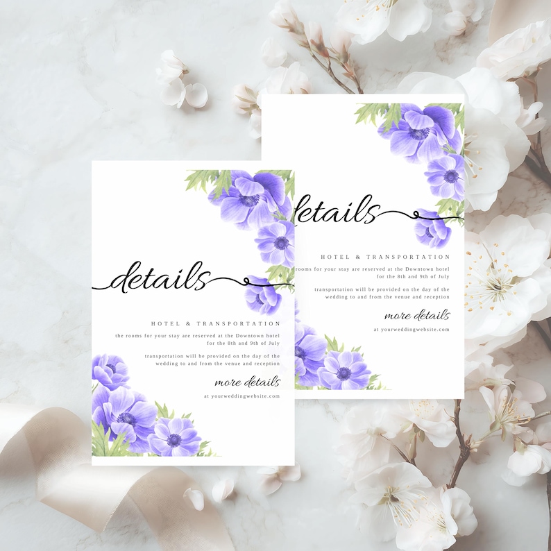May include: Two white wedding details cards with purple floral accents. The cards feature the word "details" in elegant script and include information about hotel and transportation for the event. The cards are surrounded by white flowers.