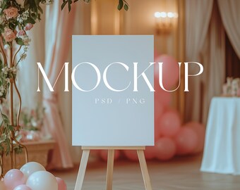 May include: A white easel with a blank canvas sign that says "MOCKUP PSD / PNG" in front of a pink and white balloon arch and a white table cloth covered table.