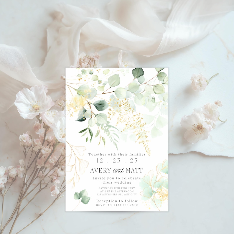 May include: A wedding invitation with floral watercolor design. The invitation features the names "AVERY and MATT" and the date "12.23.25". The invitation includes the wedding details and RSVP information. The design includes green and gold foliage.