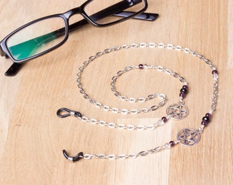 May include: Silver chain with black and clear beads and two silver pentagram charms. The chain is designed to hold glasses.