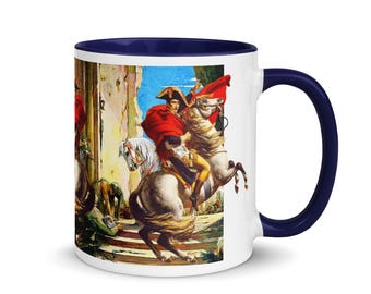 May include: White ceramic coffee mug with a blue rim and handle. The mug features a colorful image of a man on horseback riding through a stone archway.