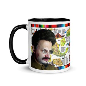 May include: White ceramic coffee mug with a black interior and handle. The mug features a portrait of a man with glasses and a mustache, along with a map of Mexico. The mug is decorated with a colorful border.