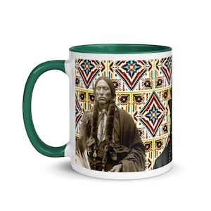 May include: White ceramic mug with a green handle and interior. The mug features a portrait of a Native American man and a colorful geometric pattern. The design includes red, blue, and yellow elements.