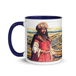 May include: White ceramic mug with a blue rim. The mug features a colorful illustration of a man in a red and gold robe and a turban, standing in front of a city.
