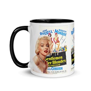 May include: White ceramic mug with a black handle and rim. The mug features a movie poster design with Marilyn Monroe and the title "Gentlemen Prefer Blondes". The poster has a vintage aesthetic.