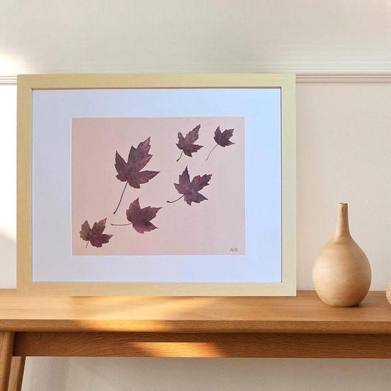 A Beige Frame Display Maple Leaves of Purple Shade Flying In The Wind During The Fall Season. Pressed Real Leaves Art. Botanical Decor.