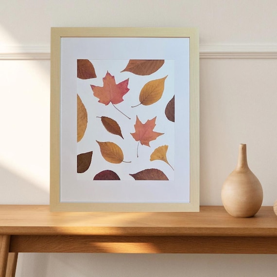 A Beige Frame Display Pressed Real Leaves With Various Shapes And Shades Of Fall (Brown, Orange And Yellow). Botanical Art. Rustic Modern.