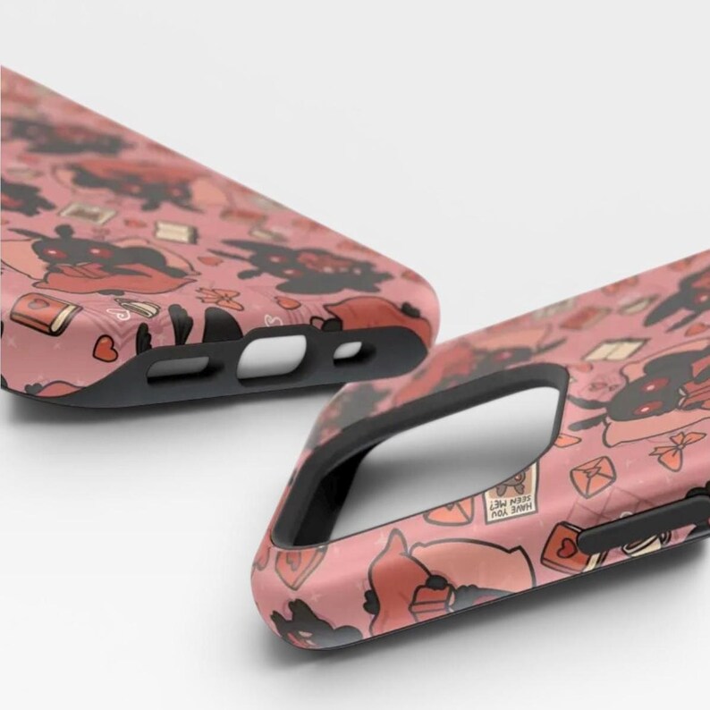 May include: Two phone cases with a dusty pink background featuring a repeating pattern of black moth-like creatures, red hearts, books, and small envelopes. One envelope has the text HAVE YOU SEEN ME? printed on it. The cases have black edges.