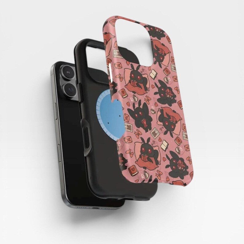 May include: A black smartphone with a protective case featuring a repeating pattern of black moth-like creatures with red eyes reading books on a dusty pink background. The case displays various small icons including open books, envelopes, and coffee cups.